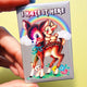 I Hate It Here Holographic Pin – Retro Rainbow Deer with Dark Humor