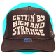 Gettin By Gettin High and Strange Trucker Hat